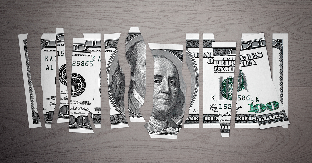 Devalued Dollar Concept. Shred Dollar Bill on a wooden table. 3d Rendering