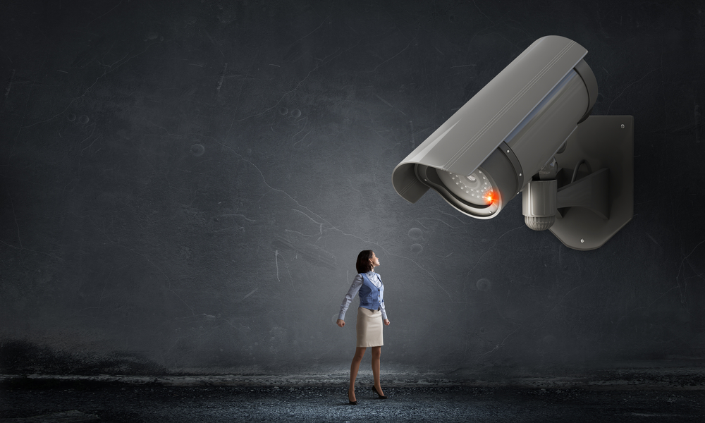 Young woman in room under CCTV camera control