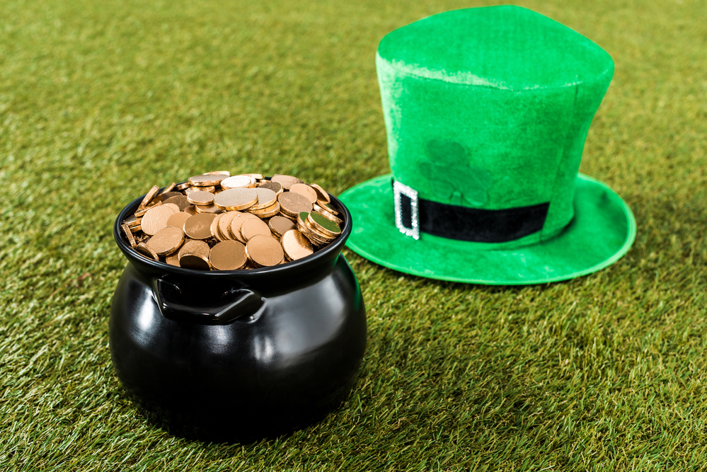 Green hat and pot of gold on grass for st patricks day
