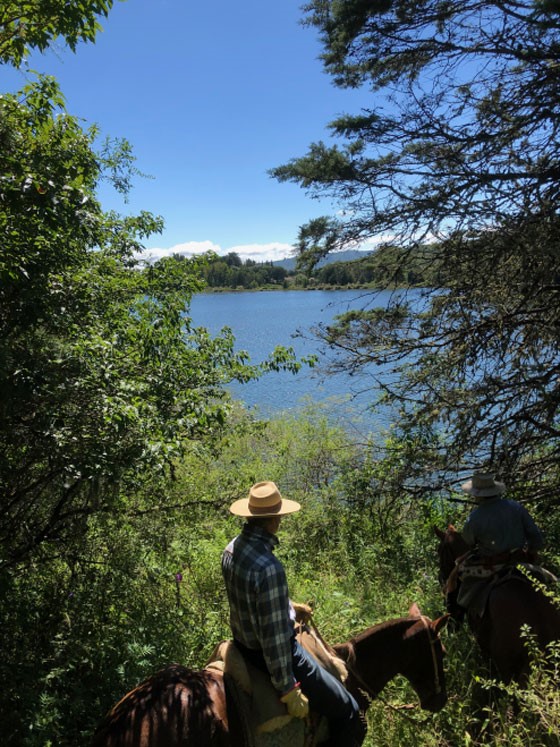 On horseback, Bill surveys a man-made lake